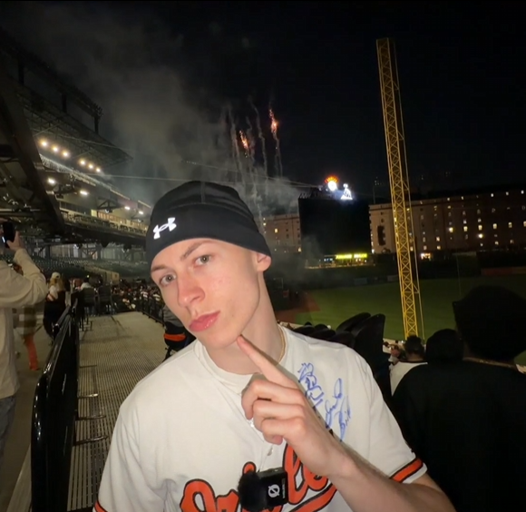 Hayden Mallon (fwhaydo) at an Orioles game with fireworks behind him